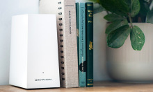 White trapezoidal Gryphon router next to books and plant