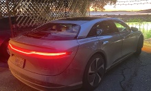 The Lucid Air Touring at sunset, San Francisco's Golden Gate in the distance. 