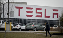 A person walks outside the Tesla Inc. solar panel factory in Buffalo, New York.