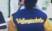 A close-up of the back of a girl's sports jacket that reads "yellowjackets".