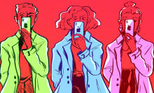 Three people standing in bright trench coats holding iPhones over their faces. 
