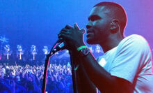 A photo of Frank Ocean holding a mic and singing photoshopped over an image of the Coachella crowd. The image has a blue and pink filter.