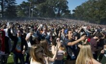 Thousands of people stand and take selfies at 4:20pm at the first sponsored 420 event in Golden Gate Park in San Francisco on April 20, 2017.