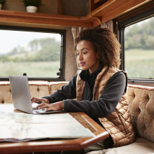 Image of woman in a camper van using her laptop
