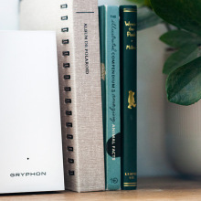 White trapezoidal Gryphon router next to books and plant
