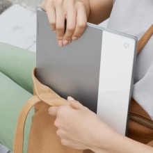 Person putting a Chromebook in a bag.