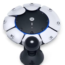 A Sony PlayStation accessible controller, which features a circular design with a joystick at the front.