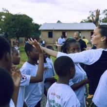 Singer and businesswoman Rihanna plays with children at a Clara Lionel Foundation event. 