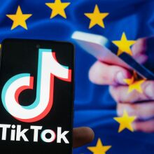 TikTok icon displayed on a phone screen with in the background European Union Flag seen in this photo illustration.