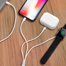 A phone, watch and headphones on a charging cable.