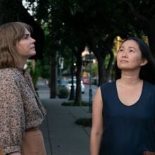 Michelle Williams and Hong Chau stand on the sidewalk in "Showing Up." 