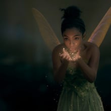 A small pixie blows glowing dust. 