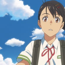 A still from the animated film 'Suzume' in which Suzume is riding her bike and meets Souta.