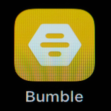 Bumble app icon the display of an iPhone SE