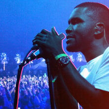 A photo of Frank Ocean holding a mic and singing photoshopped over an image of the Coachella crowd. The image has a blue and pink filter.