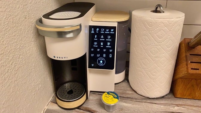 cream-colored single serve coffee maker with LED button panel
