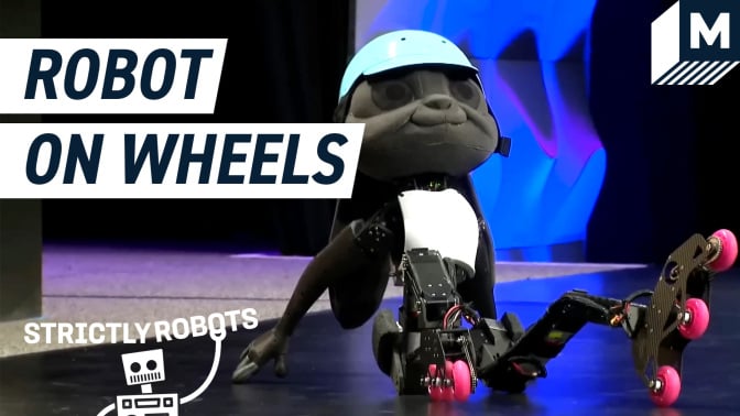 Disney's robot prototype sitting on stage wearing a pair of roller skates.