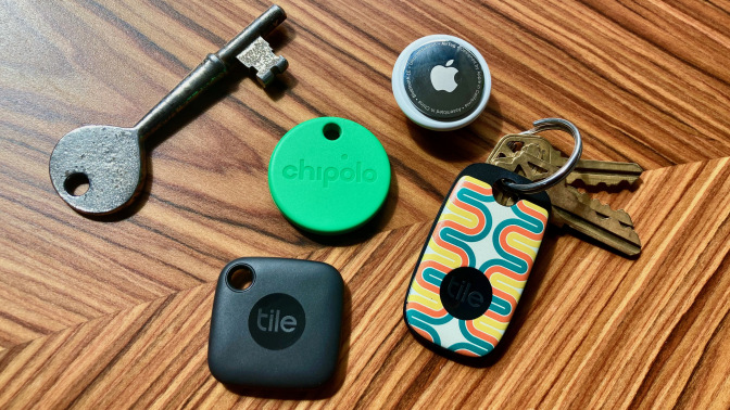 Four different bluetooth trackers on a wood table