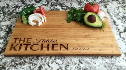 engraved wooden cutting board with produce on top