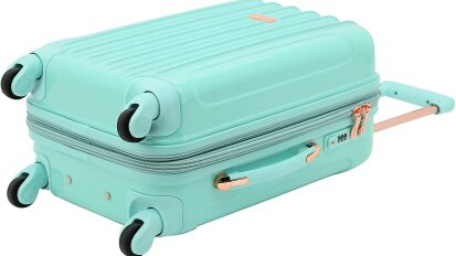 Turquoise carry on suitcase laying on its side