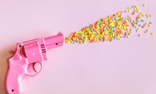 A toy gun firing sweets