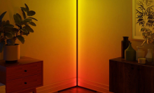 corner floor lamp in room lit up yellow and orange