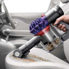  Dyson V7 Handheld Vacuum Cleaner cleaning a car.