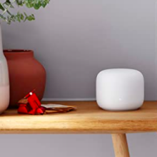 Google nest wifi mesh router on a table.