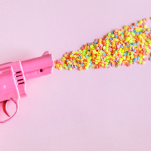 A toy gun firing sweets