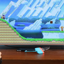 two sets of hands holding game controllers with the 3-in-1 nintendo switch docking station plugged into tv