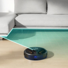 eufy robovac x8 hybrid vacuuming floor next to couch