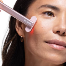Woman using rose gold SolaWave skincare wand 