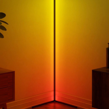 corner floor lamp in room lit up yellow and orange