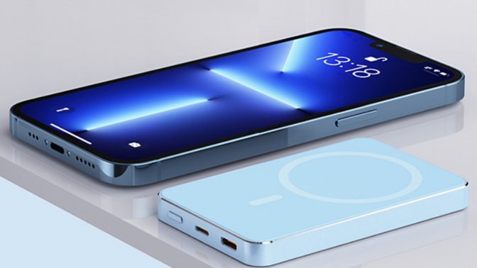 speedy mag wireless charger in blue laying next to iphone