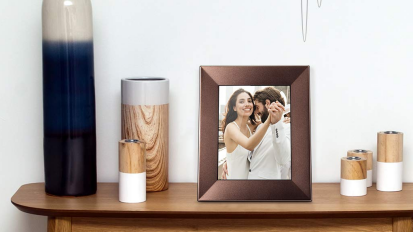 Wooden picture frame showing couple on side table with other decor