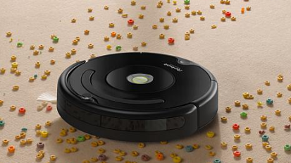 Black robot vacuum picking up cheerios