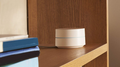 Google WiFi sitting on a counter.