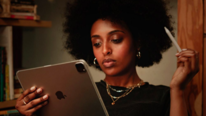person looking at ipad and holding stylus